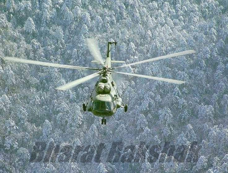 A Mi-17 flies over snow-brushed coniferous forests in the North.