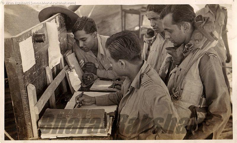 Pilots signing the authorization book on return from a photo recce sortie in 'A' Flight.