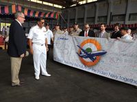 Leland White of Boeing's P8I delegation presents Vice Admiral verma with a banner signed by his team members