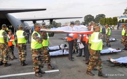 Army paramedics offload a patient from an IAF C-130J at Bagdogra